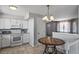 Open kitchen with white appliances, tile floors, and an adjacent dining area at 9231 W Louisiana Ave, Lakewood, CO 80232