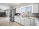 Open kitchen with stainless steel refrigerator and view of the living room at 9231 W Louisiana Ave, Lakewood, CO 80232