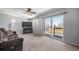 Inviting living room with plush carpet, ceiling fan, and sliding glass doors to the outdoor space at 9231 W Louisiana Ave, Lakewood, CO 80232