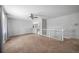 Inviting living room with plush carpet and staircase access to other areas in home at 9231 W Louisiana Ave, Lakewood, CO 80232
