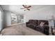 Comfortable living room with a brown sofa, carpet flooring, and ceiling fan at 9231 W Louisiana Ave, Lakewood, CO 80232