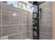 Close-up of a stylish shower with a multi-functional panel, rain shower head, and tiled surround at 9231 W Louisiana Ave, Lakewood, CO 80232