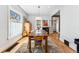 Bright dining room with a wooden table, decorative rug, and ample natural light, ideal for Gathering meals at 621 S Sherman St, Denver, CO 80209