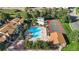 Aerial view showcasing the community pool, tennis court and clubhouse surrounded by mature trees at 7720 W 87Th Dr # J, Arvada, CO 80005