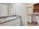 This bathroom features granite countertops and white cabinets at 7720 W 87Th Dr # J, Arvada, CO 80005