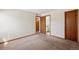 This bedroom features neutral paint tones and carpet flooring at 7720 W 87Th Dr # J, Arvada, CO 80005