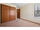 This bedroom features neutral walls, carpet flooring, and closet space at 7720 W 87Th Dr # J, Arvada, CO 80005