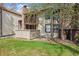 View of the property featuring a fenced-in patio and flowering tree at 7720 W 87Th Dr # J, Arvada, CO 80005