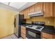 This kitchen features wooden cabinets, updated appliances, and plenty of countertop space at 7720 W 87Th Dr # J, Arvada, CO 80005