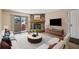 Inviting living room with a stone fireplace and sliding glass door to a private patio at 7720 W 87Th Dr # J, Arvada, CO 80005