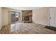 Living room showcasing the hardwood floors, stone fireplace, and access to the outdoor patio at 7720 W 87Th Dr # J, Arvada, CO 80005
