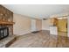 Open-concept living room with fireplace and breakfast bar overlooking the kitchen at 7720 W 87Th Dr # J, Arvada, CO 80005