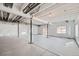 Unfinished basement with sealed concrete floor, support beams, and multiple windows at 268 Simmental Loop, Castle Rock, CO 80104