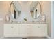 A double sink bathroom vanity with cabinets, decorative mirrors, and recessed lighting at 268 Simmental Loop, Castle Rock, CO 80104