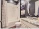 A contemporary bathroom featuring a bathtub shower, subway tile surround, and granite vanity at 268 Simmental Loop, Castle Rock, CO 80104