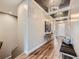 Long hallway with beautiful hardwood floors, stylish chandeliers and elegant decor and bench seat at 268 Simmental Loop, Castle Rock, CO 80104