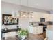Bright eat-in kitchen with stainless appliances, decorative lighting, and dining area with an art display at 268 Simmental Loop, Castle Rock, CO 80104
