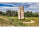 Historic silo on a grassy hill with walking path and unique architectural detail at 268 Simmental Loop, Castle Rock, CO 80104