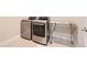 Laundry room showcasing modern washer and dryer set with adjacent stainless steel storage rack at 268 Simmental Loop, Castle Rock, CO 80104