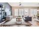 Bright living room featuring stylish furnishings, large windows with shutters, and hardwood floors at 268 Simmental Loop, Castle Rock, CO 80104