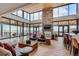 Bright lounge with floor-to-ceiling windows, stylish decor, stone fireplace, and comfortable seating at 268 Simmental Loop, Castle Rock, CO 80104