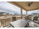 Covered patio with comfortable seating and a view of the surrounding neighborhood and landscape at 268 Simmental Loop, Castle Rock, CO 80104