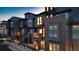 Townhouses with brick and metal siding, evening lighting at 5004 S Prince Pl, Littleton, CO 80123