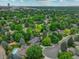 Aerial view of residential area with lush green trees and skyline in background at 6338 S Oneida Ct, Centennial, CO 80111