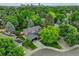 Aerial view of home with a large tree and long driveway surrounded by greenery at 6338 S Oneida Ct, Centennial, CO 80111