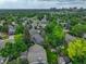 Aerial view of homes with city skyline and lush greenery and mature trees at 6338 S Oneida Ct, Centennial, CO 80111