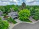 Aerial view of home with mature trees, landscaping, and a long driveway at 6338 S Oneida Ct, Centennial, CO 80111