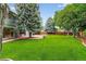 Lush backyard featuring a large patio and a vast green lawn, ideal for outdoor activities and relaxation at 6338 S Oneida Ct, Centennial, CO 80111