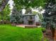 Large backyard with mature trees, patio, and lush green lawn perfect for outdoor enjoyment at 6338 S Oneida Ct, Centennial, CO 80111