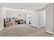 Large storage area in basement with neutral colored carpet, window, and a laundry room at 6338 S Oneida Ct, Centennial, CO 80111