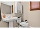 Cozy powder room with pedestal sink and updated fixtures at 6338 S Oneida Ct, Centennial, CO 80111