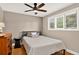 Cozy bedroom with a ceiling fan and a large window at 6338 S Oneida Ct, Centennial, CO 80111