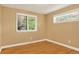 This bedroom has two large windows, hardwood floors and baseboard trim at 6338 S Oneida Ct, Centennial, CO 80111