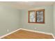 This empty bedroom has hardwood floors and a window for natural light at 6338 S Oneida Ct, Centennial, CO 80111