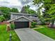Two-story home with brick and siding exterior, a basketball hoop, and a driveway at 6338 S Oneida Ct, Centennial, CO 80111