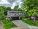 Two-story home with a basketball hoop, large driveway, and green lawn at 6338 S Oneida Ct, Centennial, CO 80111