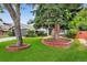 Well-manicured front yard with mature trees and manicured landscaping at 6338 S Oneida Ct, Centennial, CO 80111