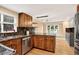 Well-lit kitchen featuring granite countertops, stainless steel appliances, and wood flooring at 6338 S Oneida Ct, Centennial, CO 80111