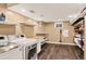 Well-organized laundry room features modern washer and dryer, shelves, and wood-look floors at 6338 S Oneida Ct, Centennial, CO 80111