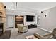 Open living room featuring a stone fireplace, carpet flooring, and built-in cabinets at 6338 S Oneida Ct, Centennial, CO 80111
