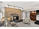 Cozy Gathering room featuring a stone fireplace, carpet flooring, and built-in cabinets at 6338 S Oneida Ct, Centennial, CO 80111