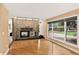 Bright living room featuring a stone fireplace, hardwood floors, and large windows at 6338 S Oneida Ct, Centennial, CO 80111
