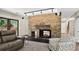 Comfortable Gathering room featuring a stone fireplace, plush carpeting, and cozy seating at 6338 S Oneida Ct, Centennial, CO 80111