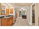 The main en suite bath features wood cabinets, a granite counter, and mirrored closet doors at 6338 S Oneida Ct, Centennial, CO 80111