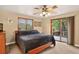Comfortable main bedroom with a ceiling fan and sliding door to the outside deck at 6338 S Oneida Ct, Centennial, CO 80111