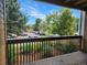 View from a balcony shows a parking area with mature trees and a blue sky on a clear day at 2802 Sundown Ln # 103, Boulder, CO 80303